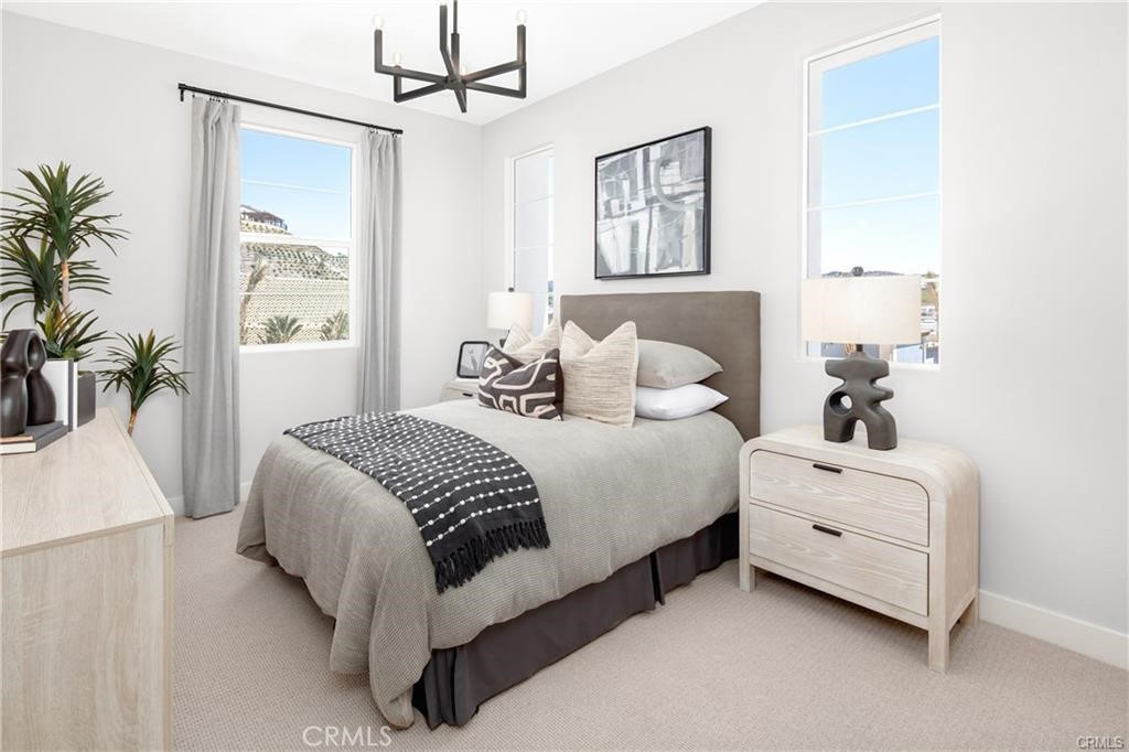 242 Solaro Court Walnut, CA 91789 - Photo 12 of 15 a bedroom with a white bed and a chandelier