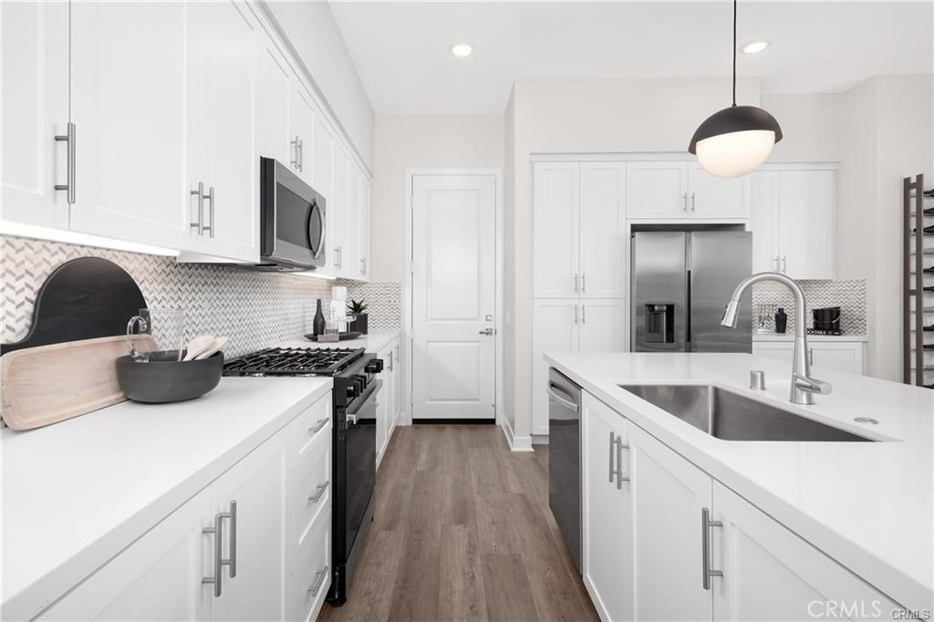 242 Solaro Court Walnut, CA 91789 - Photo 5 of 15 a kitchen with a sink a stove and cabinets