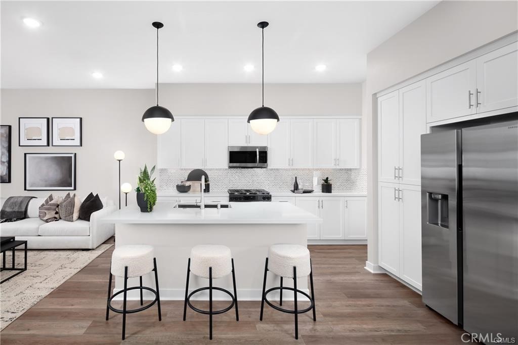 242 Solaro Court Walnut, CA 91789 - Photo 7 of 15 a kitchen with kitchen island a dining table chairs stainless steel appliances and cabinets