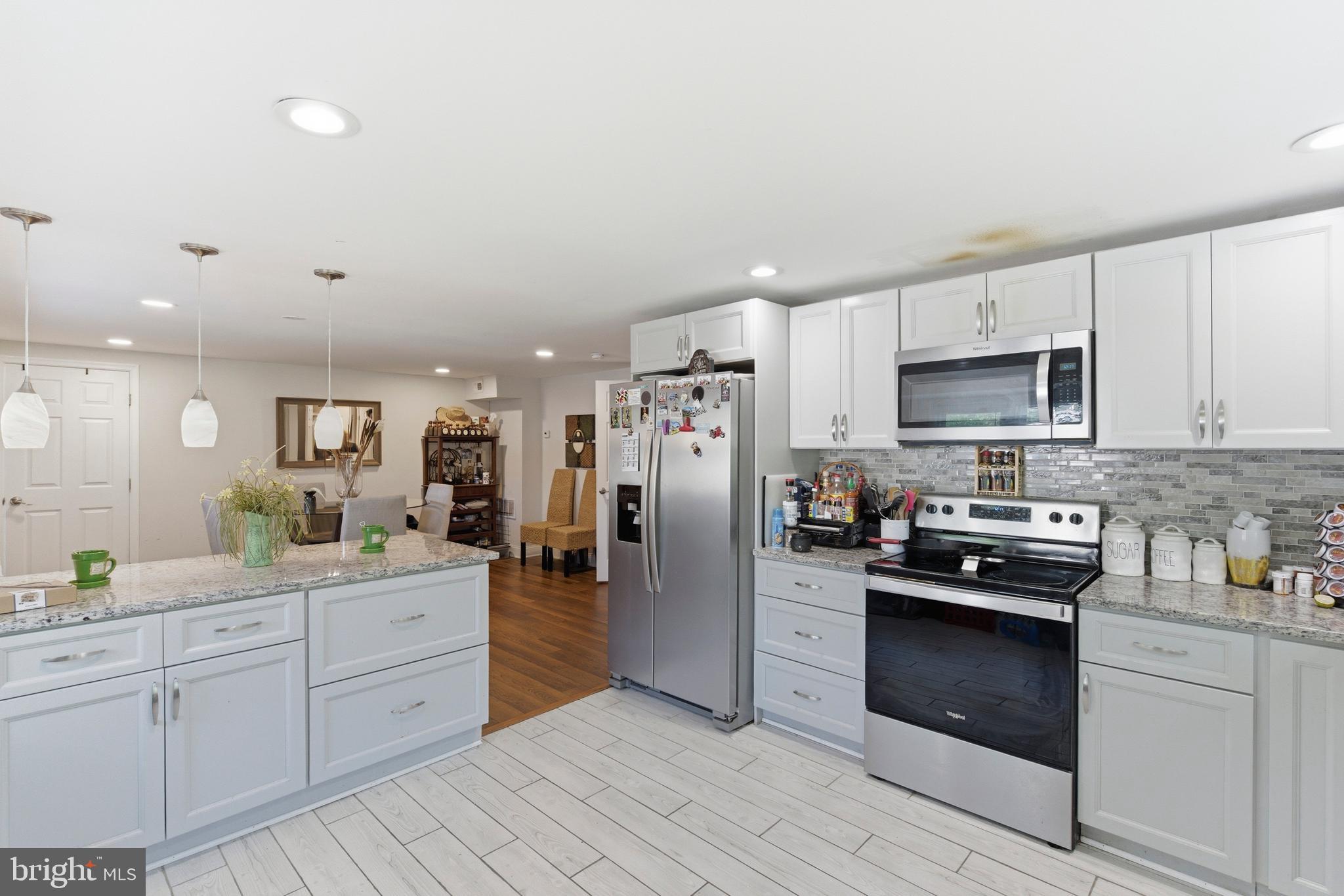 912 Shelley Road Towson, MD 21286 - Photo 13 of 27 a kitchen with white cabinets and stainless steel appliances