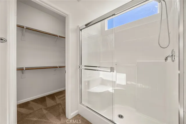 a bathroom with a glass shower door