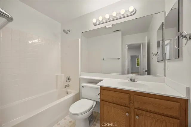 a bathroom with a sink a toilet and a large mirror