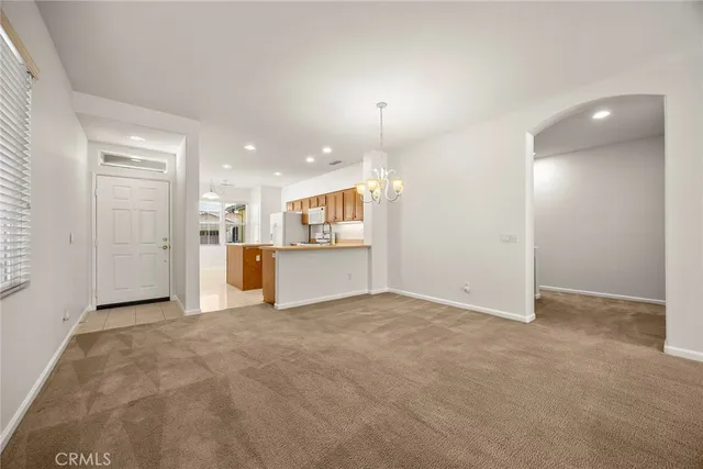 a view of an empty room with a kitchen