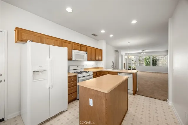 a kitchen with a stove a refrigerator and a sink