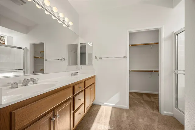 a bathroom with a double vanity sink and a mirror