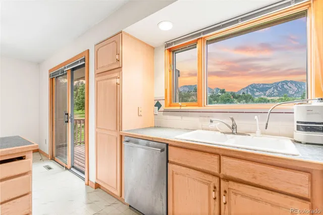a bathroom with a granite countertop sink and a large mirror