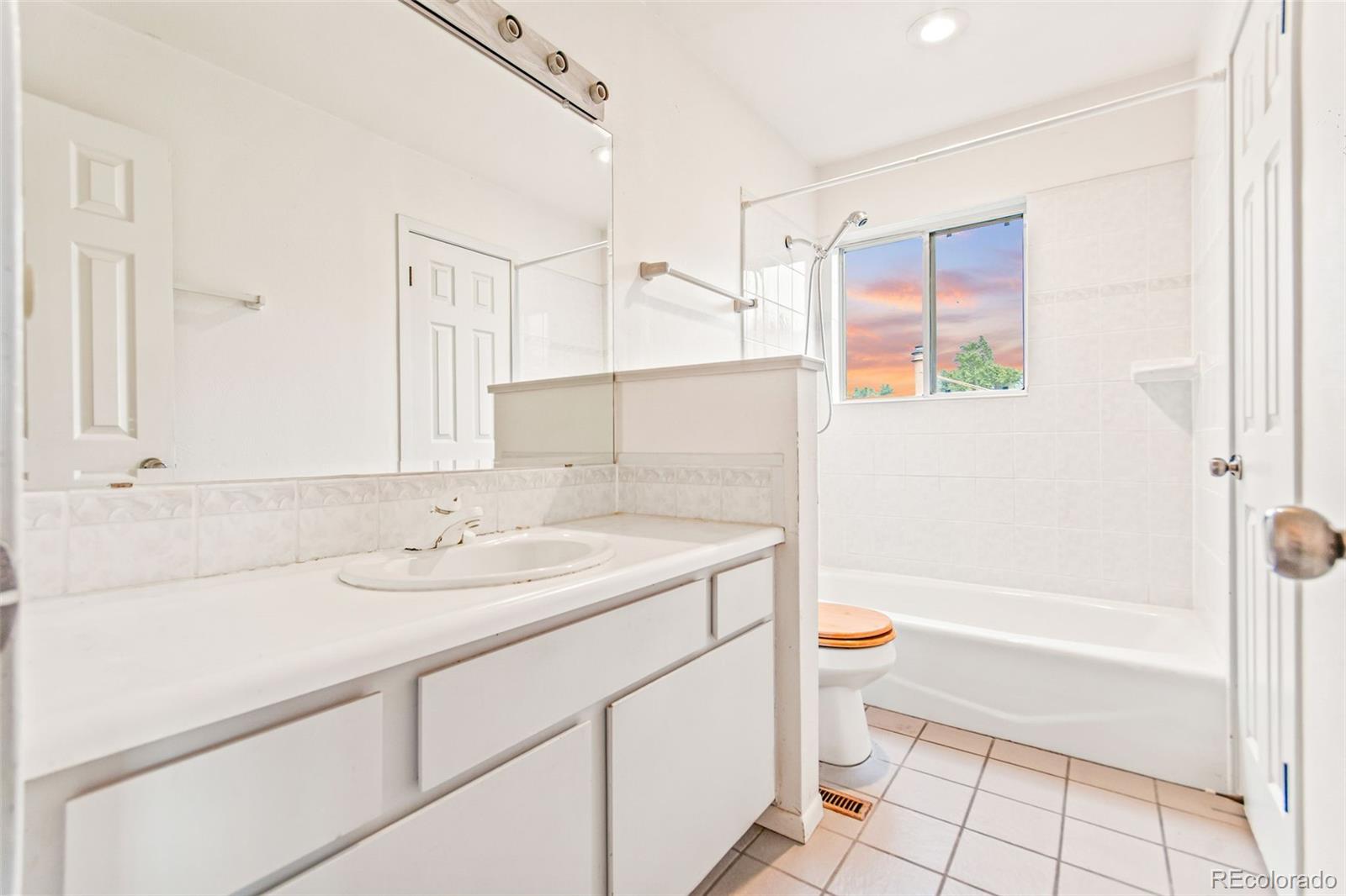 4814 West Moorhead Circle Boulder, CO 80305 - Photo 18 of 35 a bathroom with a sink a toilet and a large mirror