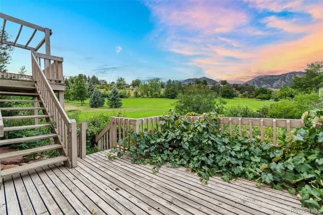 a view of a yard with wooden floor and fence