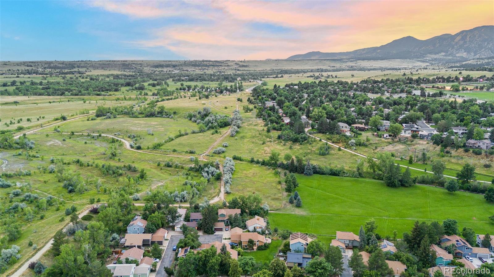 4814 West Moorhead Circle Boulder, CO 80305 - Photo 33 of 35 a view of a lush green field with lots of plants and trees in the background