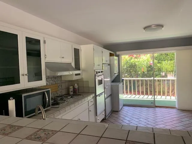 a view of a porch with chairs and refrigerator