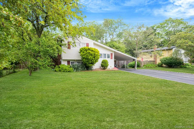 a front view of house with yard and green space