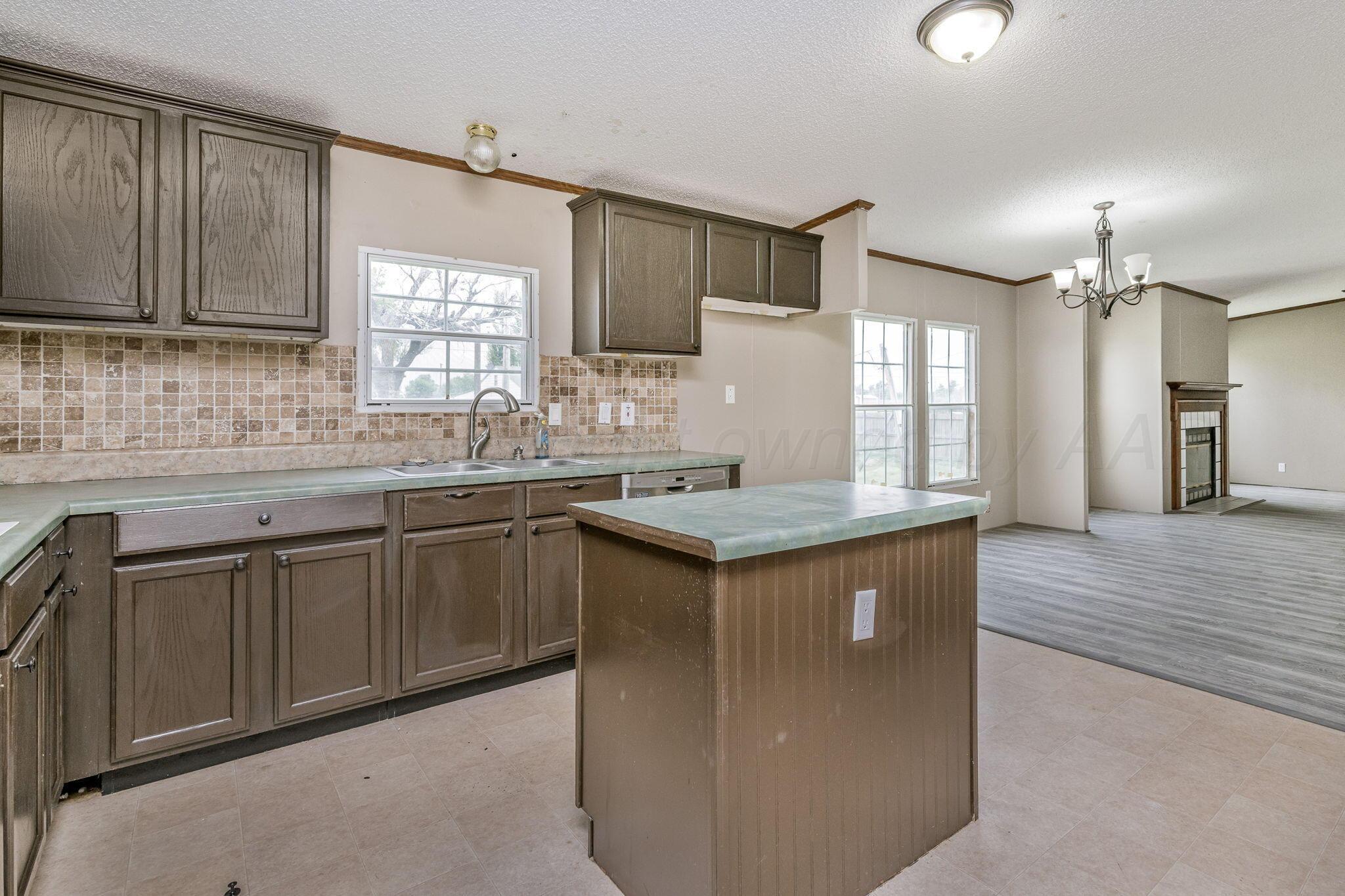 101 Collier Avenue Groom, TX 79039 - Photo 11 of 21 a kitchen with stainless steel appliances granite countertop a sink stove and refrigerator