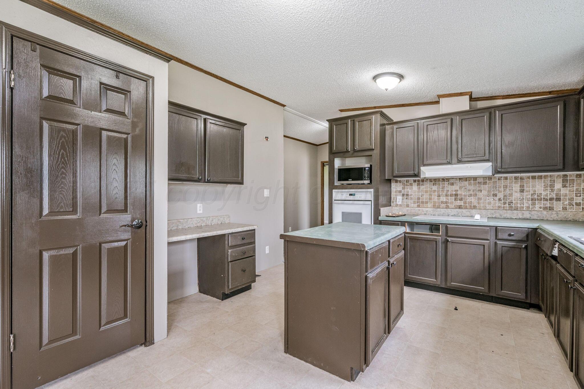 101 Collier Avenue Groom, TX 79039 - Photo 10 of 21 a kitchen with stainless steel appliances granite countertop a stove top oven sink and refrigerator