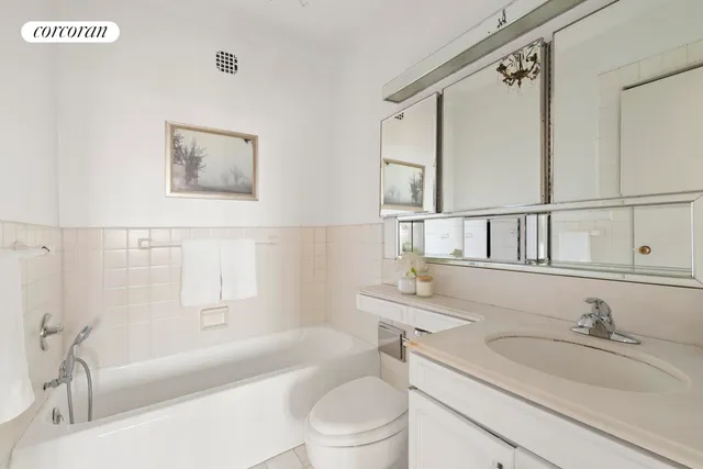 a bathroom with a granite countertop sink toilet and a mirror