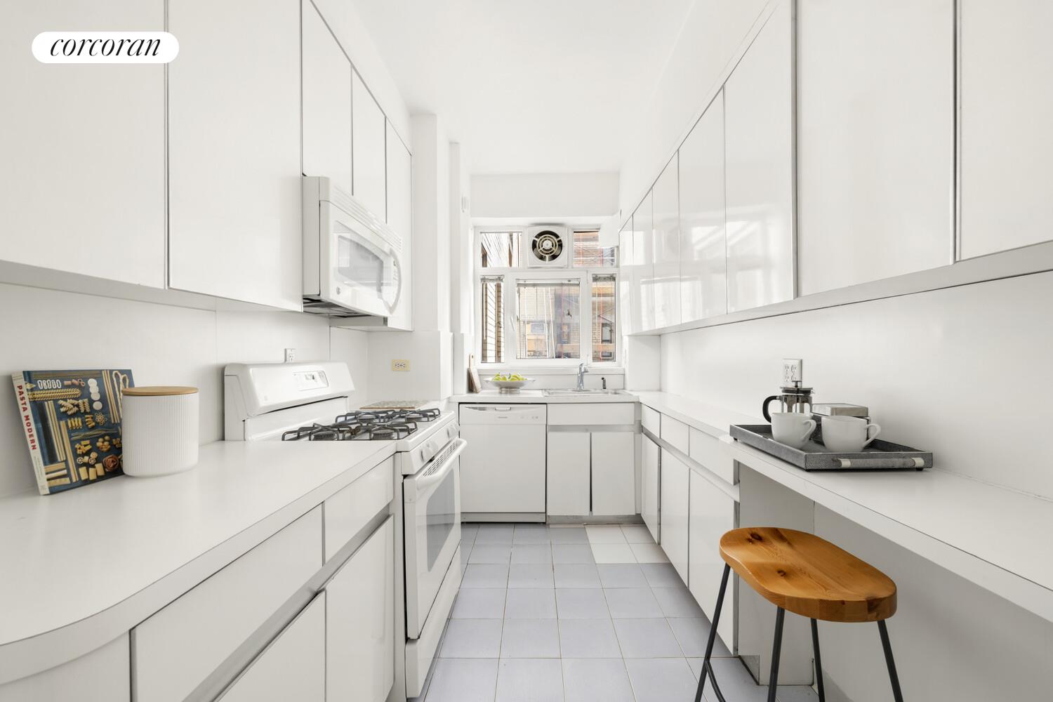 875 5th Avenue, Unit 15A Manhattan, NY 10065 - Photo 12 of 20 a kitchen with stainless steel appliances granite countertop a sink and a stove