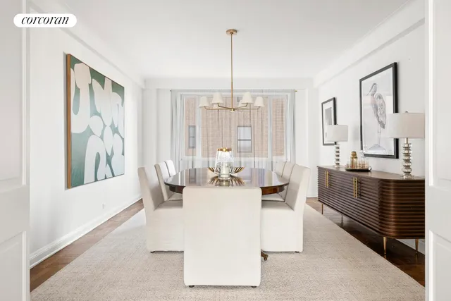 a living room with furniture and painting on the wall