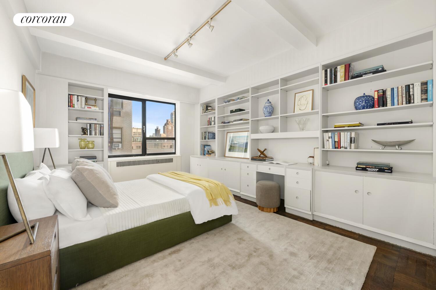 875 5th Avenue, Unit 15A Manhattan, NY 10065 - Photo 8 of 20 a bedroom with a bed cabinets and a window