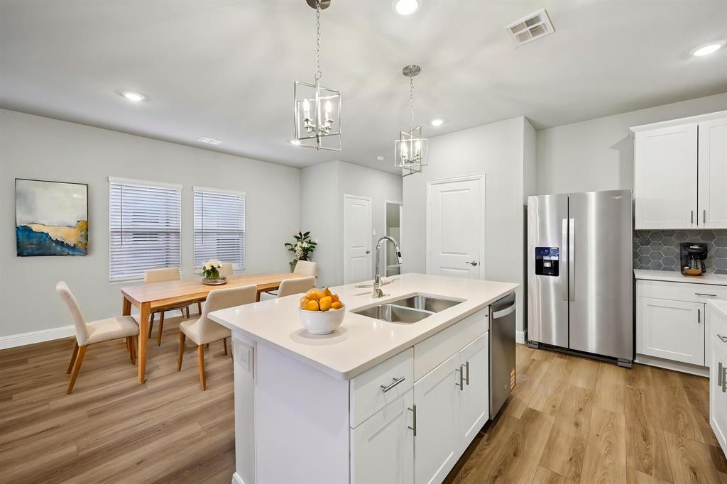 1721 Arches Road Anna, TX 75409 - Photo 16 of 39 a kitchen with stainless steel appliances granite countertop a sink a stove and a refrigerator