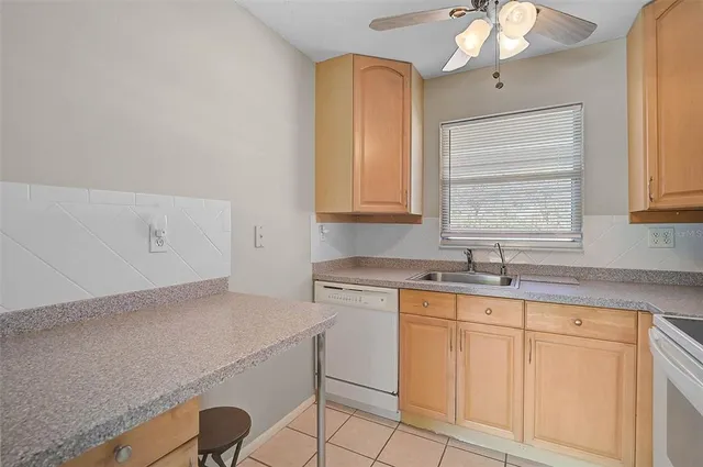 a kitchen with a sink cabinets and window