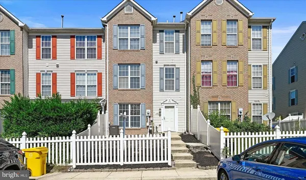 front view of a brick house with a small yard