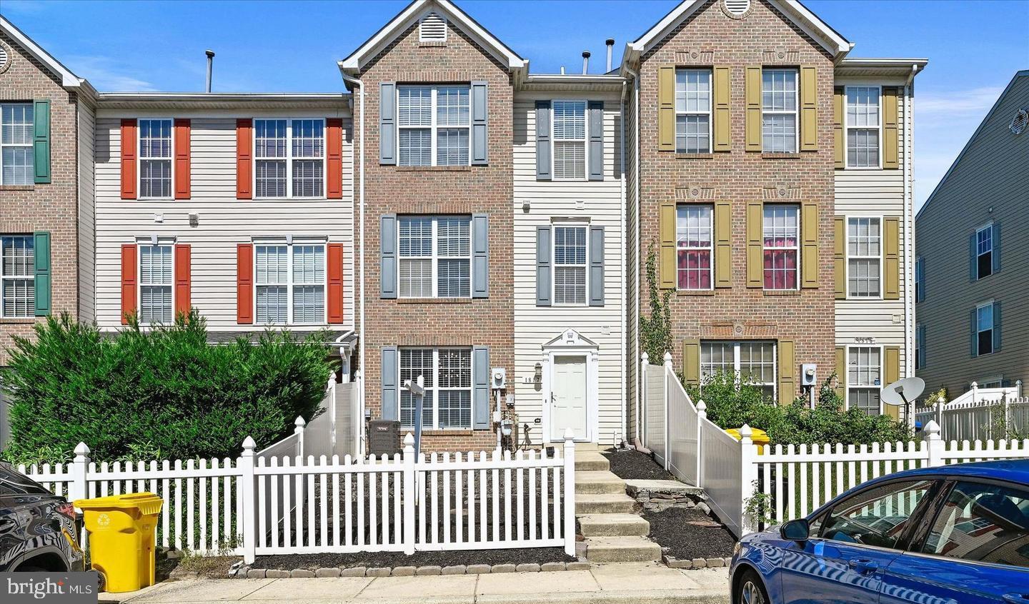front view of a brick house with a small yard