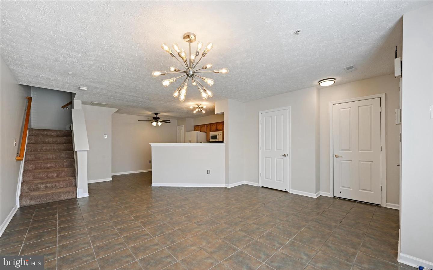 1817 Triple Feather Road Severn, MD 21144 - Photo 6 of 10 a view of a room with stairs and a chandelier