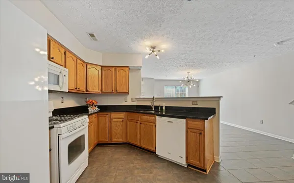 a view of an empty room and a ceiling fan