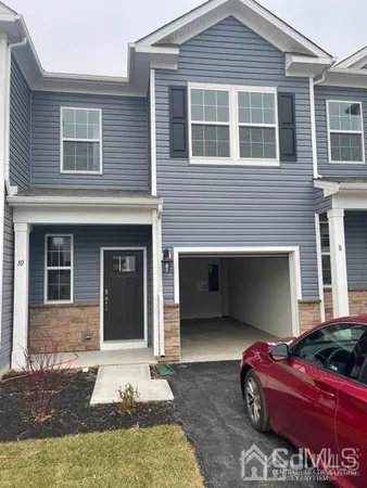 a front view of a house with parking space