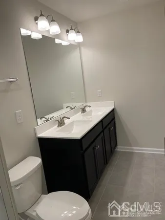 a bathroom with a sink vanity and a toilet