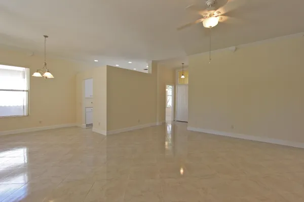 en empty room with windows and entrance