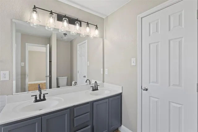 a bathroom with a double vanity sink and a mirror
