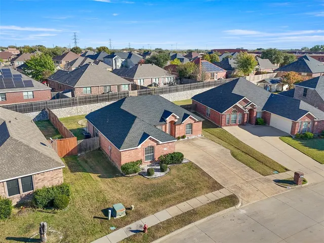 an aerial view of residential houses with outdoor space