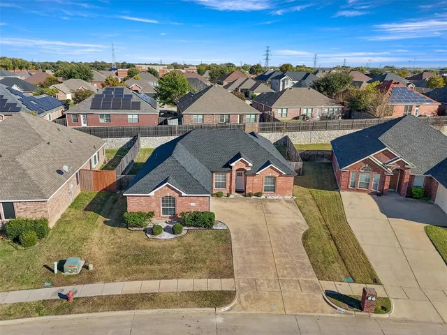 an aerial view of residential houses with outdoor space