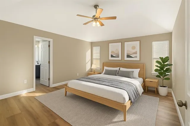 a bedroom with a bed and a potted plant