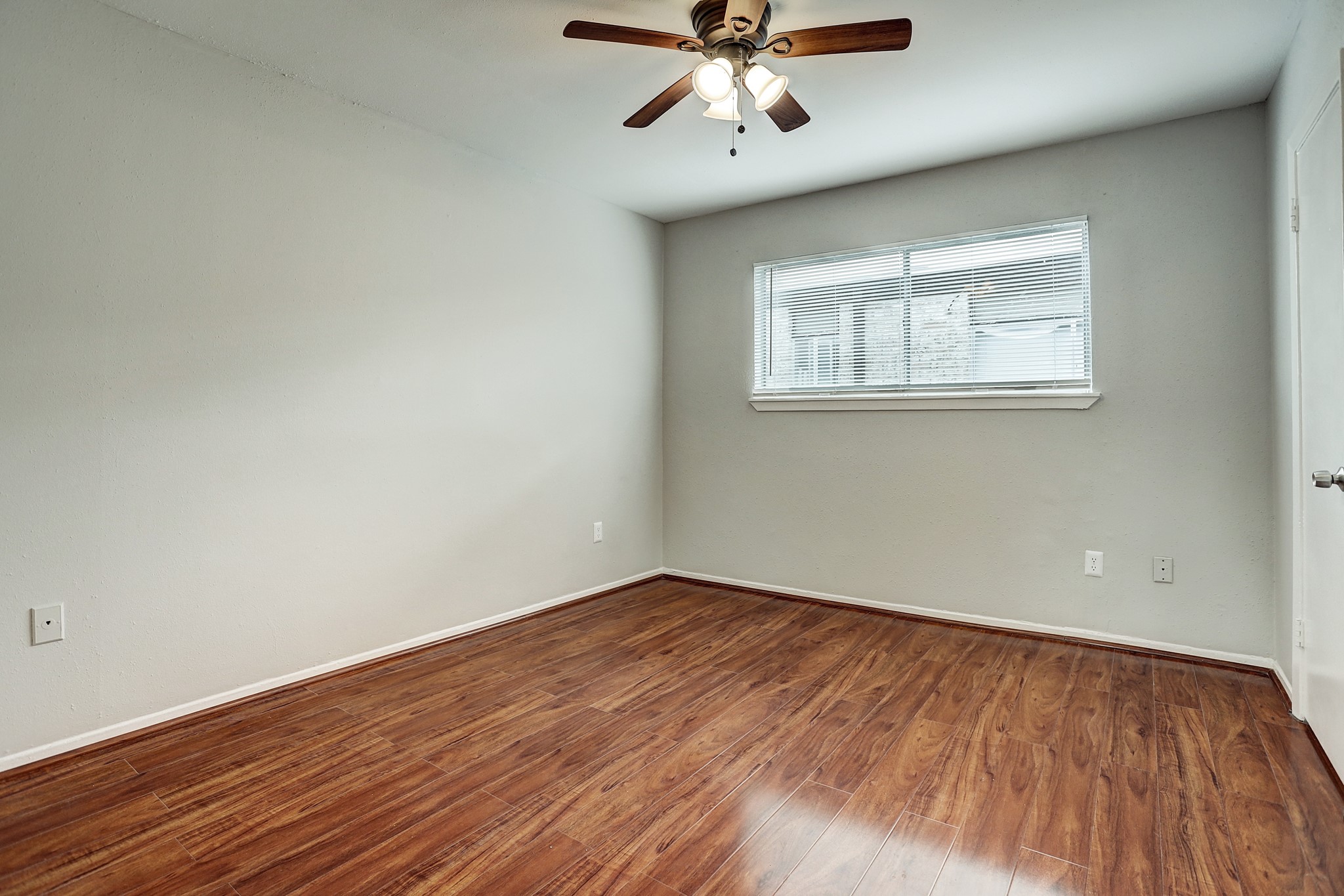 513 Ridge Street, Unit 21 Houston, TX 77009 - Photo 2 of 9 wooden floor in an empty room with a window