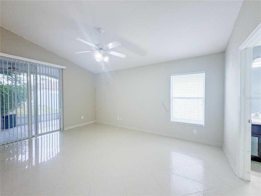 4150 Branchside Lane Wesley Chapel, FL 33543 - Photo 18 of 32 an empty room with chandelier fan and windows