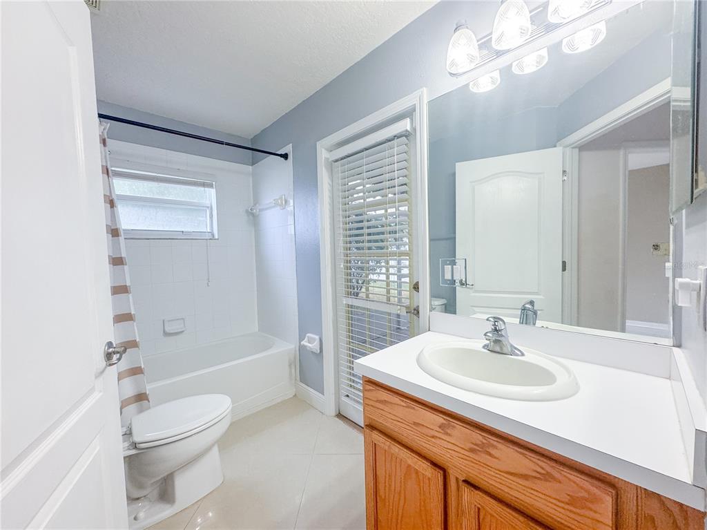 4150 Branchside Lane Wesley Chapel, FL 33543 - Photo 20 of 32 a bathroom with a sink a toilet and shower