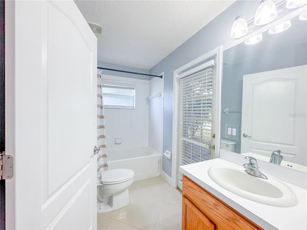 4150 Branchside Lane Wesley Chapel, FL 33543 - Photo 21 of 32 a bathroom with a sink a toilet and shower