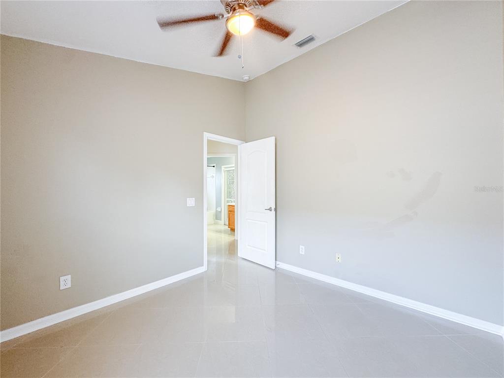4150 Branchside Lane Wesley Chapel, FL 33543 - Photo 26 of 32 an empty room with a ceiling fan and carpet