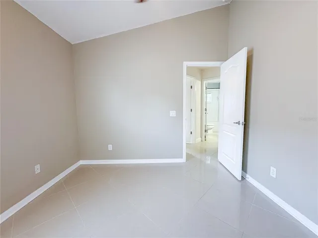 a view of an empty room with a ceiling fan
