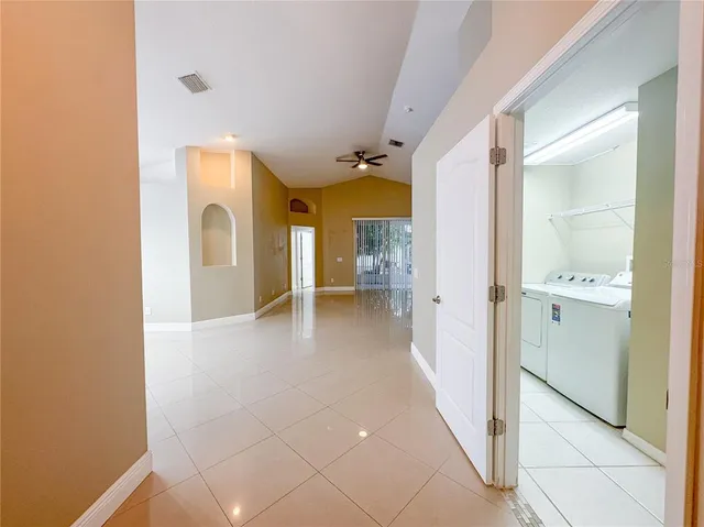 a view of a hallway with wooden shelves