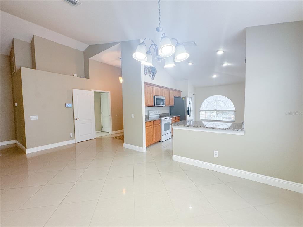 4150 Branchside Lane Wesley Chapel, FL 33543 - Photo 7 of 32 a view of a kitchen with a refrigerator a sink a dishwasher and a refrigerator