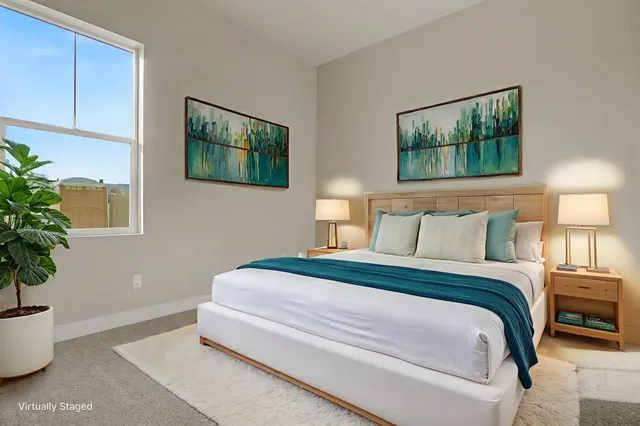 a bedroom with bed and a potted plant