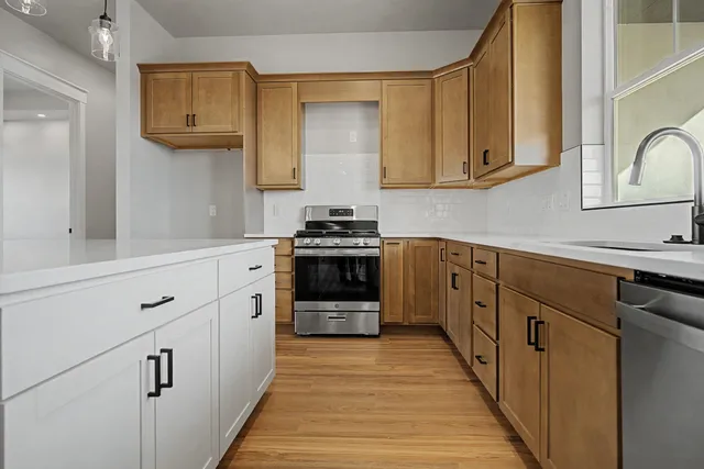 a kitchen with cabinets a sink and appliances