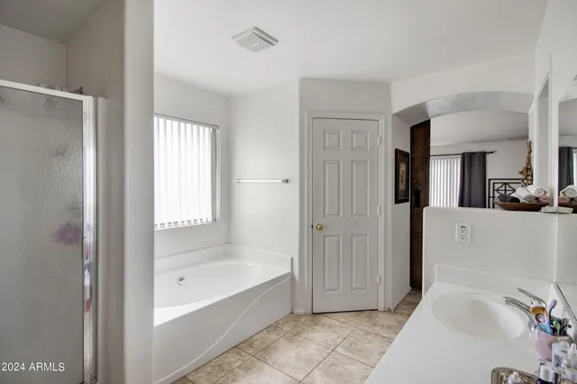 a bathroom with a bathtub and a shower