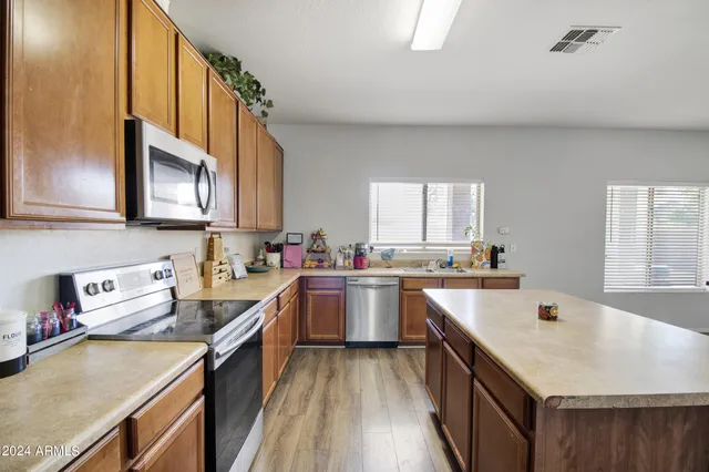a kitchen with a sink stove top oven and cabinets