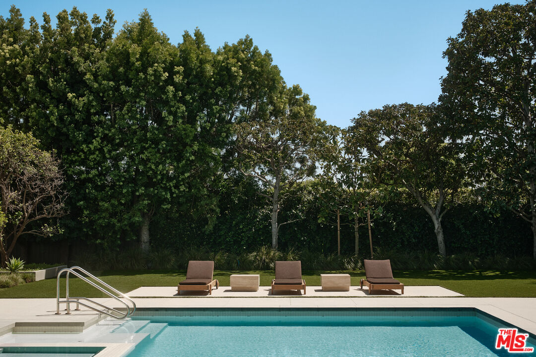 713 North Hillcrest Road Beverly Hills, CA 90210 - Photo 15 of 28 a view of a fountain and fire pit in the patio