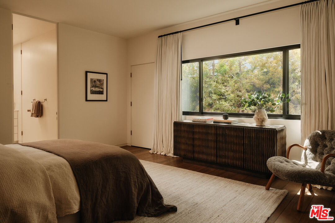 713 North Hillcrest Road Beverly Hills, CA 90210 - Photo 23 of 28 a bedroom with a bed and a large window