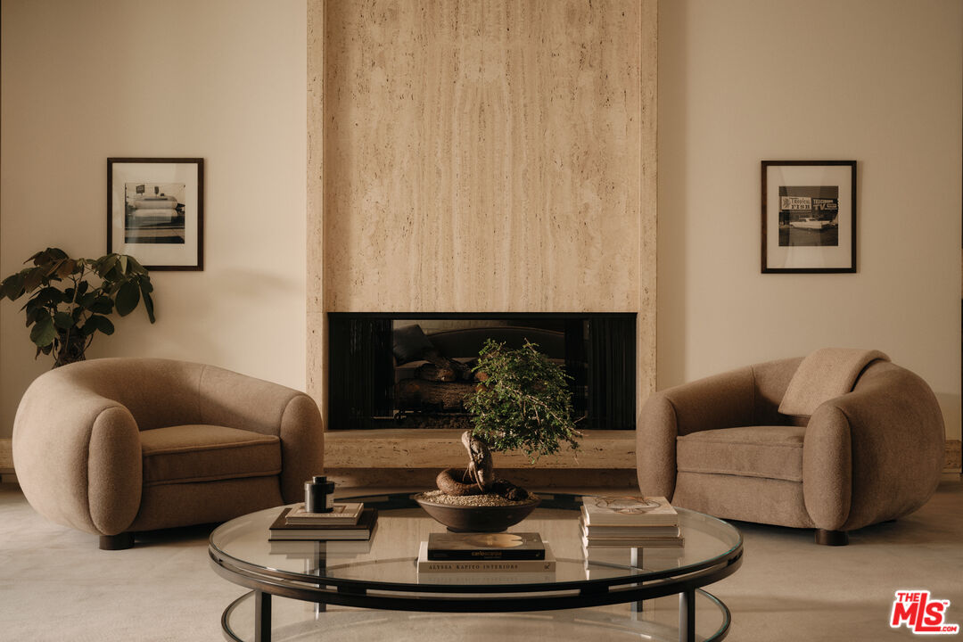 713 North Hillcrest Road Beverly Hills, CA 90210 - Photo 7 of 28 a living room with furniture and a fireplace