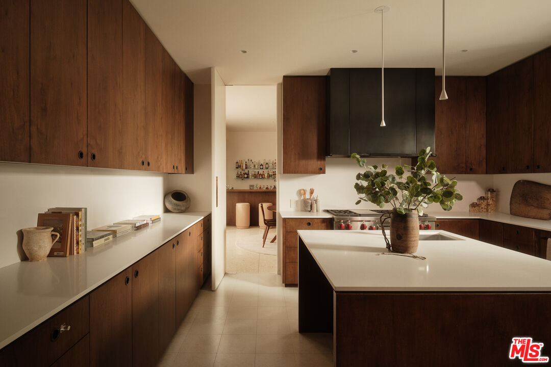 713 North Hillcrest Road Beverly Hills, CA 90210 - Photo 9 of 28 a kitchen with a sink and cabinets